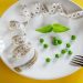 Diet white plate with centimeter peas and basil